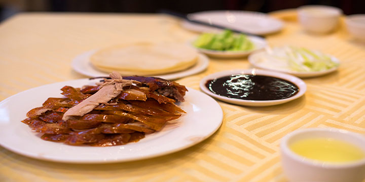 Beijing roast duck served with thin pancakes, scallion and cucumber Beijing roast duck served with thin pancakes, scallion and cucumber