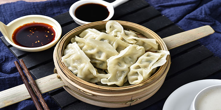 Boiled Chinese dumplings served in a bamboo basket Boiled Chinese dumplings served in a bamboo basket