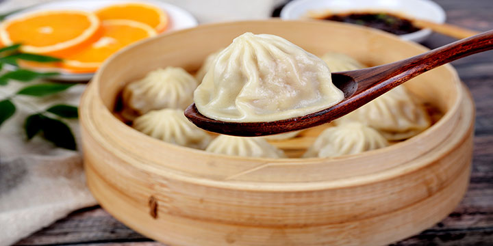 Xiao long bao served hot in a bamboo steamer Xiao long bao served hot in a bamboo steamer