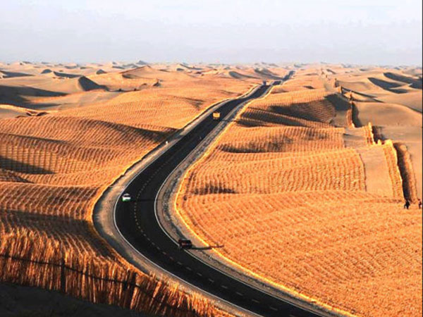 Tarim Desert Highway crossing dunes in Xinjiang