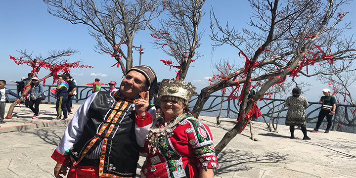 Older travelers meeting local people during a culturally focused China journey Older travelers meeting local people during a culturally focused China journey