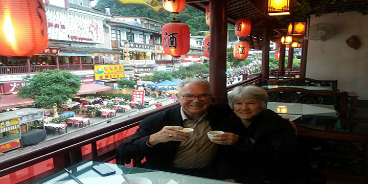 Older travelers sharing a seated meal at a restaurant in China Older travelers sharing a seated meal at a restaurant in China