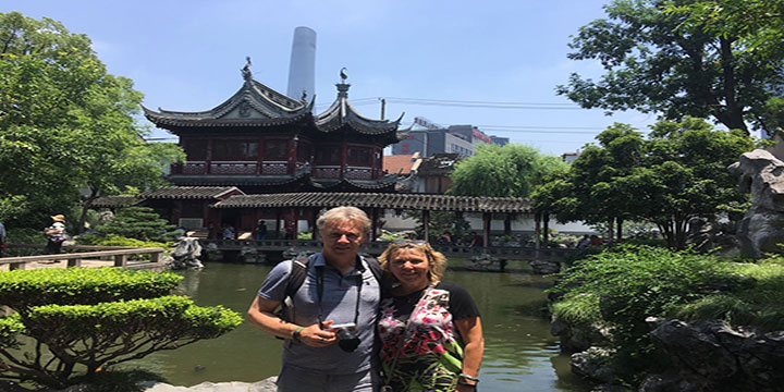 Older travelers visiting a traditional garden in comfortable spring weather Older travelers visiting a traditional garden in comfortable spring weather