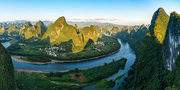 Licensed Li River boat traveling through Guilin karst scenery Licensed Li River boat traveling through Guilin karst scenery