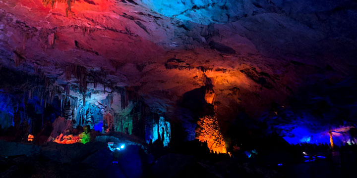 Illuminated limestone formations inside Reed Flute Cave in Guilin Illuminated limestone formations inside Reed Flute Cave in Guilin