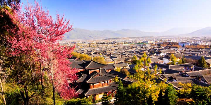 Traditional rooftops and mountain setting of Lijiang Old Town Traditional rooftops and mountain setting of Lijiang Old Town