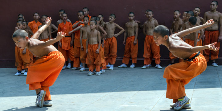 Young martial arts students practicing at a Shaolin training school Young martial arts students practicing at a Shaolin training school