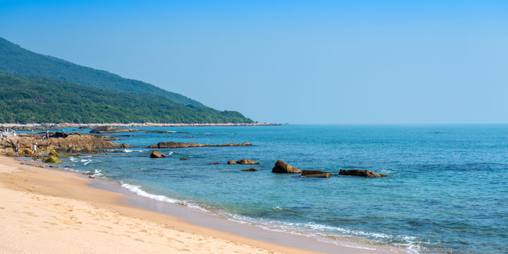 Sandy beach and calm sea at Sanya on Hainan Island Sandy beach and calm sea at Sanya on Hainan Island
