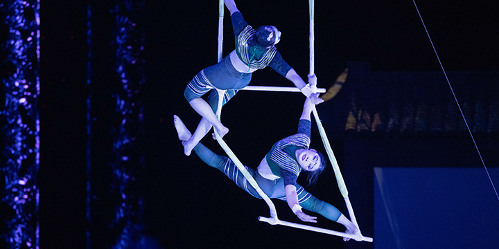 Aerial acrobats performing under stage lighting in Shanghai