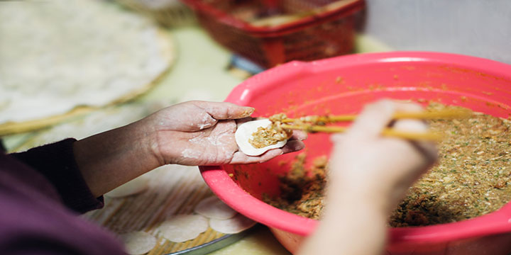 Hands shaping dumplings during a hosted cooking lesson in Xi’an Hands shaping dumplings during a hosted cooking lesson in Xi’an