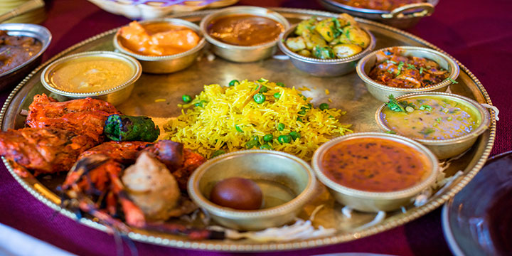 Indian curry, rice and accompaniments served as a thali meal Indian curry, rice and accompaniments served as a thali meal