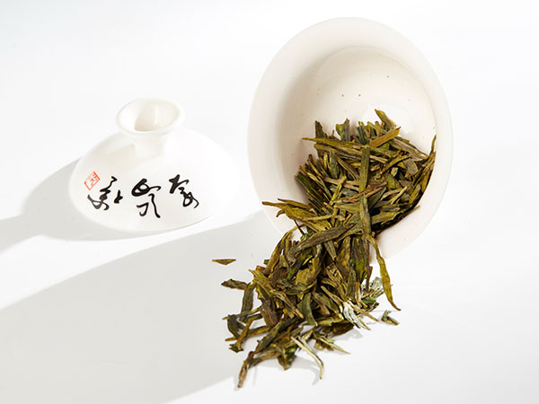 Flat green Longjing tea leaves ready for brewing