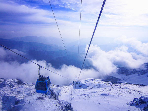 Jade Dragon Snow Mountain cable car above a winter landscape