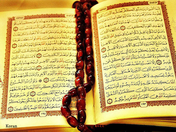 Open Quran with prayer beads used as an illustrative publishing image Open Quran with prayer beads used as an illustrative publishing image
