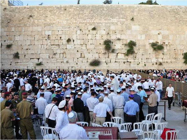 Worshippers gather near a holy site during Laylat al-Miraj