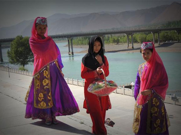 Salar women demonstrating a local cultural tradition Salar women demonstrating a local cultural tradition