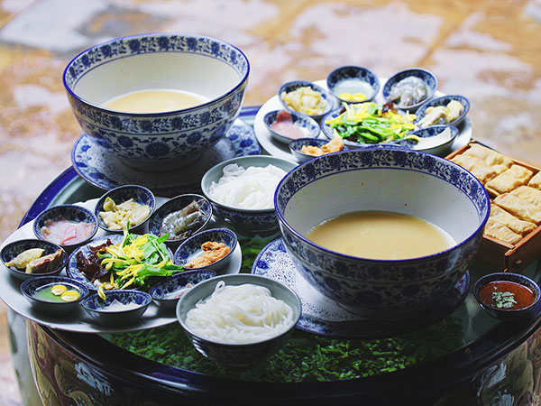 Yunnan crossing-the-bridge rice noodles with separate ingredients