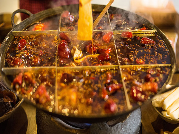 Diners sharing a Chinese hotpot meal Diners sharing a Chinese hotpot meal