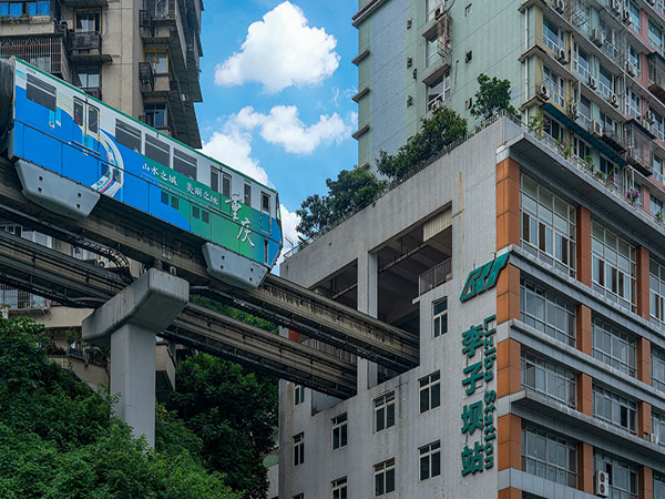Chongqing metro train passing through a residential building at Liziba