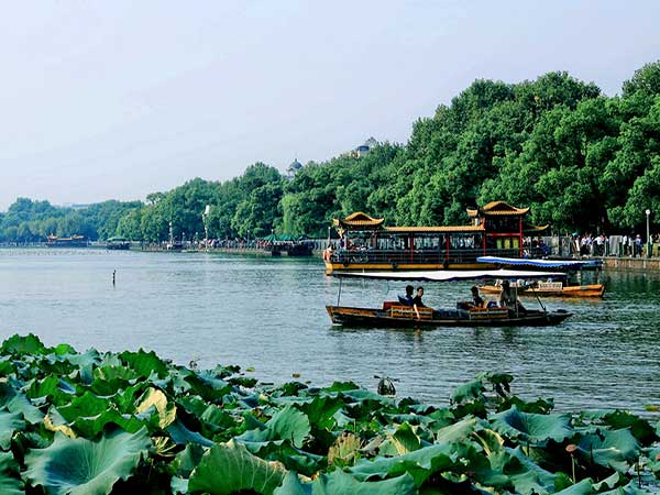 West Lake boats and lotus in Hangzhou illustrating its cultural landscape West Lake boats and lotus in Hangzhou illustrating its cultural landscape