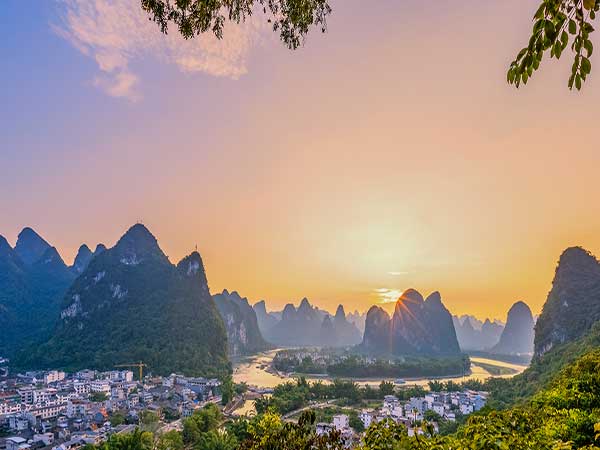 Guilin city and karst mountains at sunset