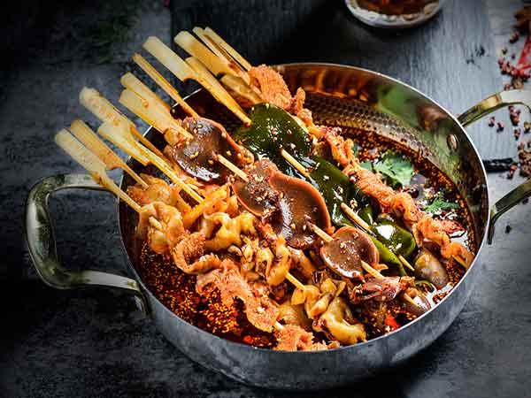 Spicy malatang with vegetables, noodles and skewered ingredients
