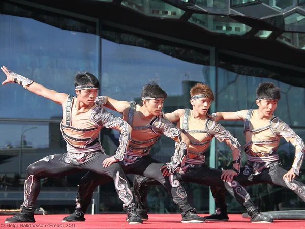Chinese acrobatics troupe performing a synchronized stage routine