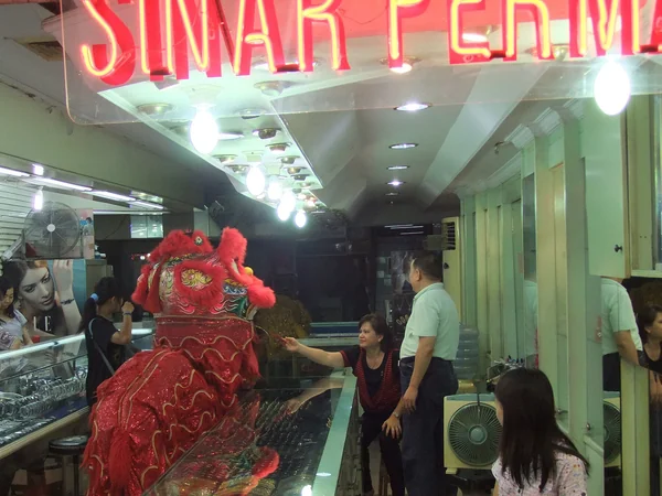 A red envelope being presented during a lion dance celebration