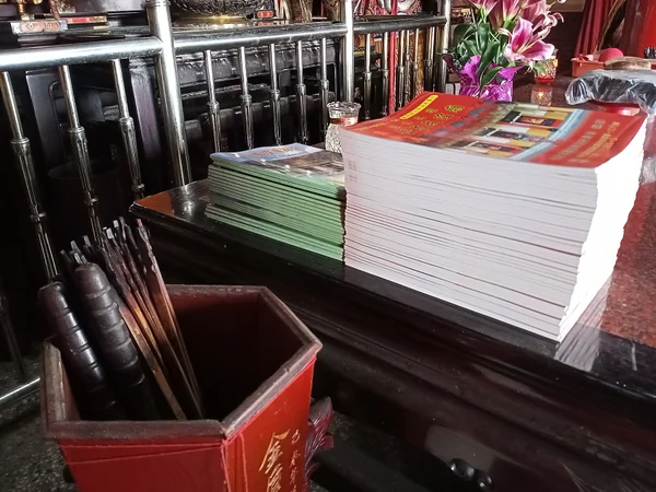 Fortune sticks beside Chinese lunar calendar booklets at a temple Fortune sticks beside Chinese lunar calendar booklets at a temple