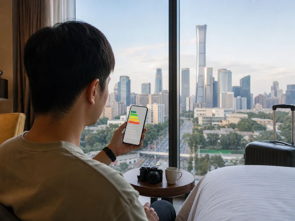 Traveler checking a color-coded air-quality forecast from a China hotel room Traveler checking a color-coded air-quality forecast from a China hotel room