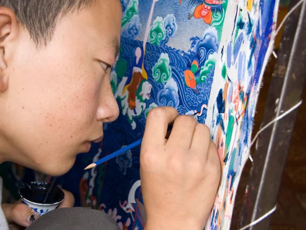 Thangka artist drawing an iconometric grid Thangka artist drawing an iconometric grid
