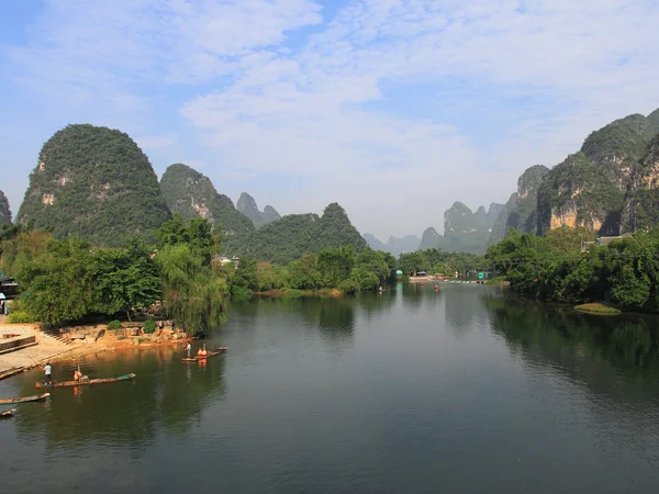 Green karst scenery beside the Yulong River in Yangshuo