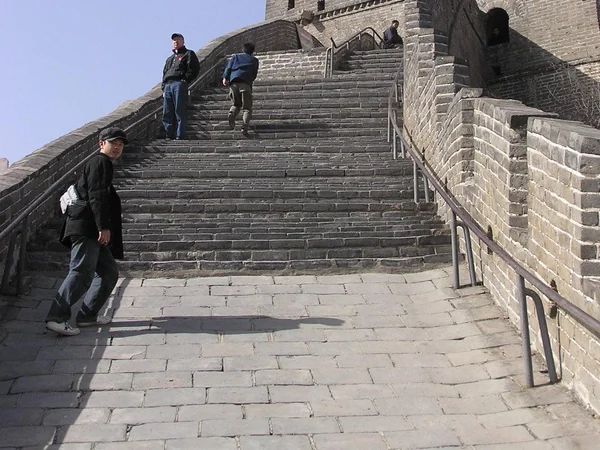 Real hikers walking a restored Great Wall ridge near Beijing