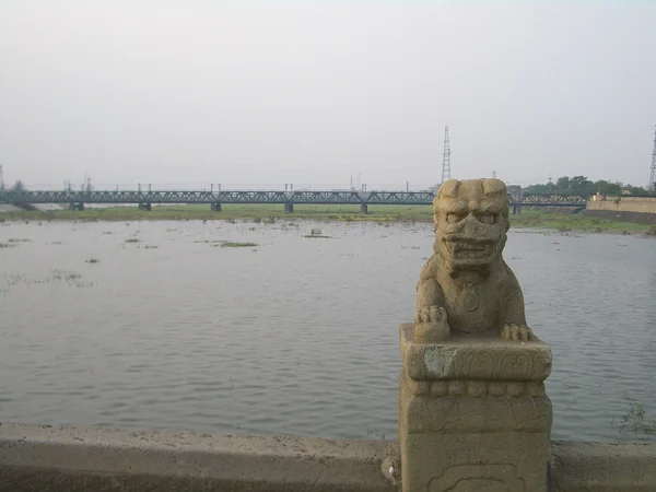 Carved stone lion on the balustrade of Lugou Bridge in Beijing