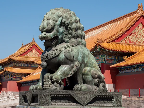 Guardian lion and palace roofs inside Beijing’s Forbidden City