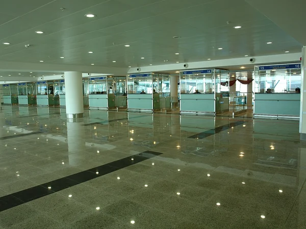 Passport control inspection booths inside an international airport Passport control inspection booths inside an international airport