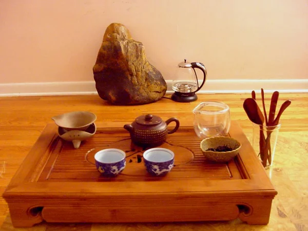 Gongfu tea service arranged with a teapot, pitcher and small cups