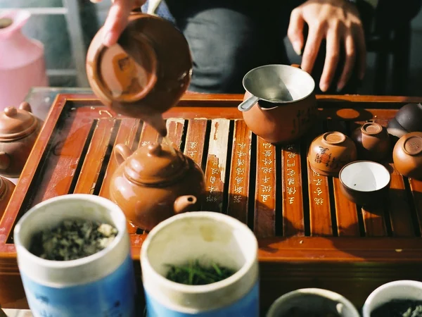 Host pouring Chinese tea carefully during a tasting session