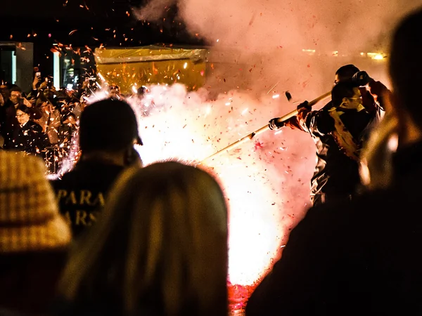 Professionals lighting a string of firecrackers during a public Chinese New Year event Professionals lighting a string of firecrackers during a public Chinese New Year event