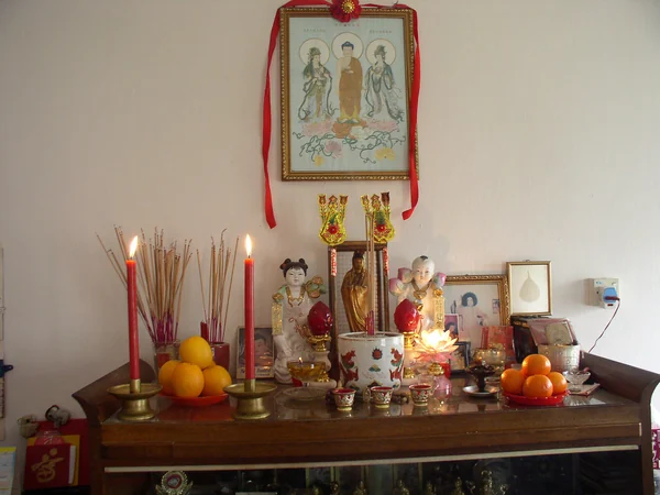 A Chinese folk altar with incense and offerings A Chinese folk altar with incense and offerings