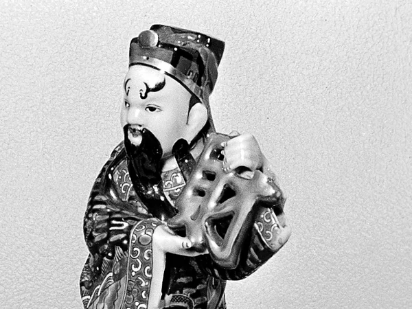 A porcelain figure representing the Chinese God of Wealth A porcelain figure representing the Chinese God of Wealth