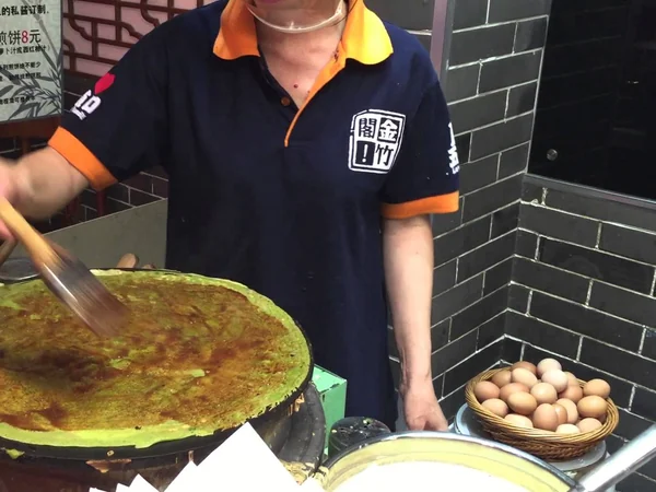 Freshly prepared jianbing as an example of a local Chinese breakfast Freshly prepared jianbing as an example of a local Chinese breakfast