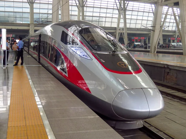 Passengers boarding a high-speed train at a station in China