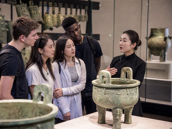 International students learning about Chinese bronze artifacts