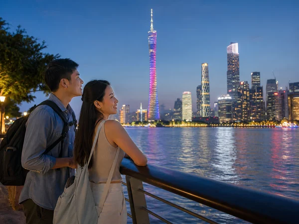 Southeast Asian travelers viewing the Guangzhou skyline