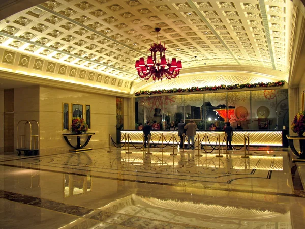A staffed hotel reception desk used for guest check-in