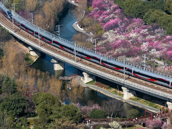 A high-speed train crossing a bridge through mountainous terrain in China A high-speed train crossing a bridge through mountainous terrain in China