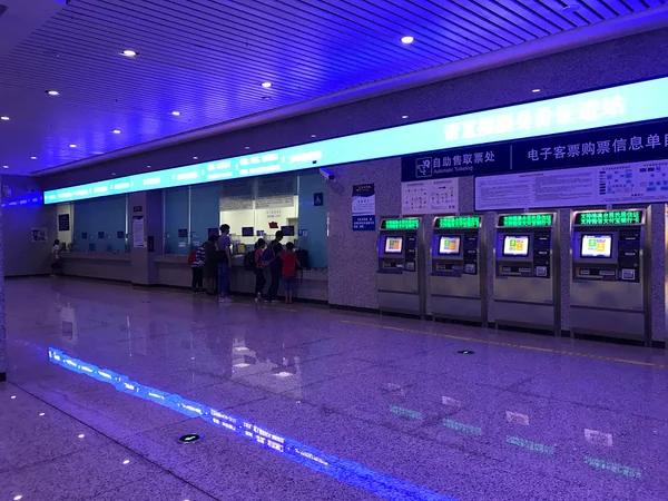 Passengers using a ticket service counter at a railway station in China Passengers using a ticket service counter at a railway station in China