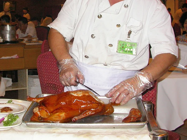 Peking duck carved beside the table in a Beijing restaurant Peking duck carved beside the table in a Beijing restaurant