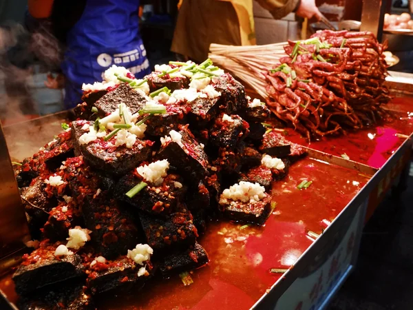 Changsha-style stinky tofu served with chili and aromatic toppings Changsha-style stinky tofu served with chili and aromatic toppings